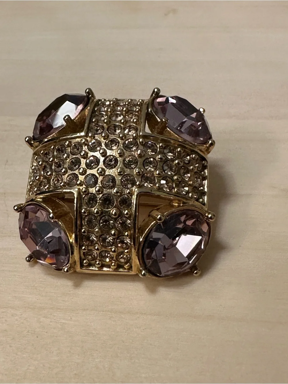 Monet gold-tone brooch with an abstract geometric design with purple stones